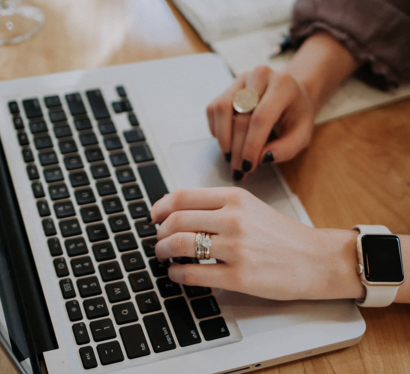 Picture of a women typing on a laptop